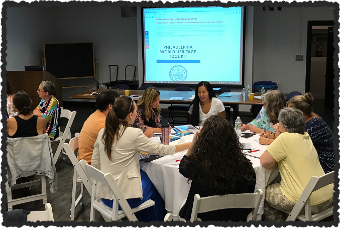 Photo of teachers sitting at a round table during orientation.