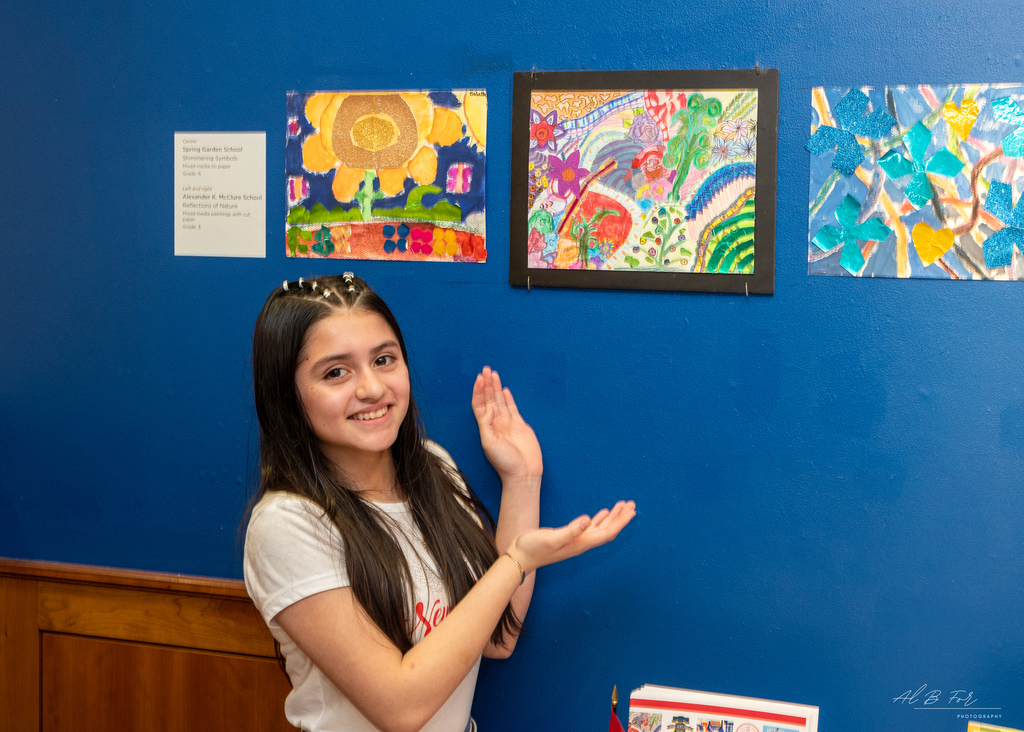 Photo of student presenting their artwork at the Woodmere Art Museum.