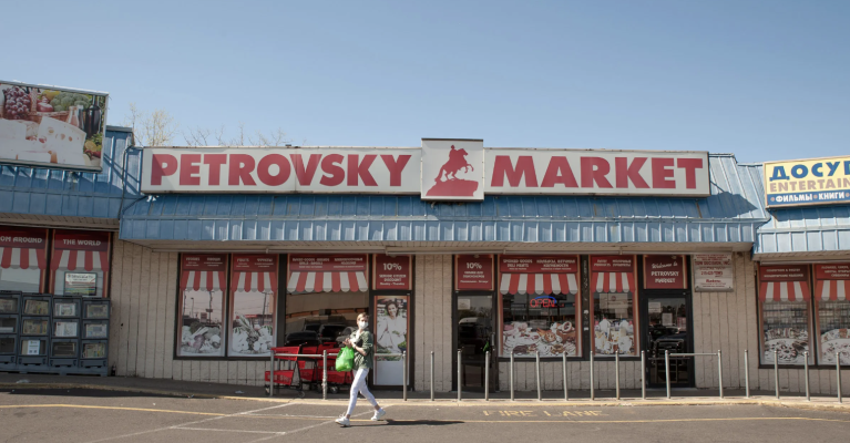 Photo of Petrovsky Market in Northeast Philadelphia. A person is walking in front of the store.
